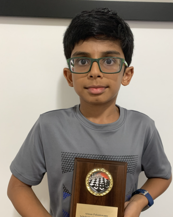 Atman Palamiswany, Showdown U1000 Chess Champion, holding his customized plaque.