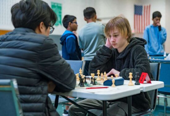 USCF Expert Sean Tan (left) and Scotty Robinson (right) calculate variations as the clock ticks down past the 3 minute mark.