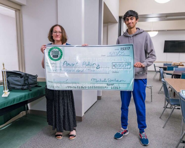Stacia Pugh (left) presents NM Anant Adury (right) with his scholarship prize.